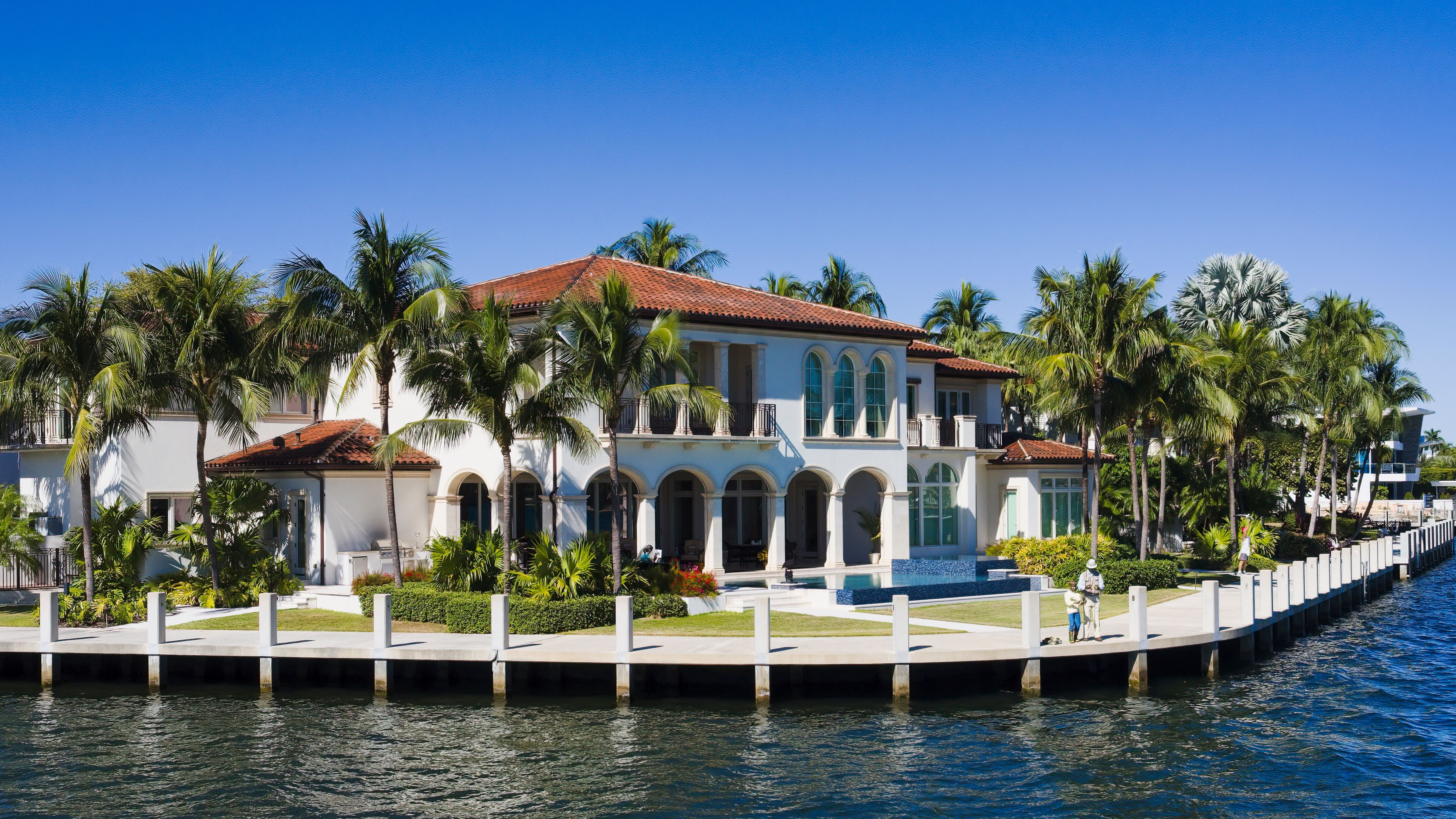 Lakefront home with palm trees and private dock in Windermere, Florida